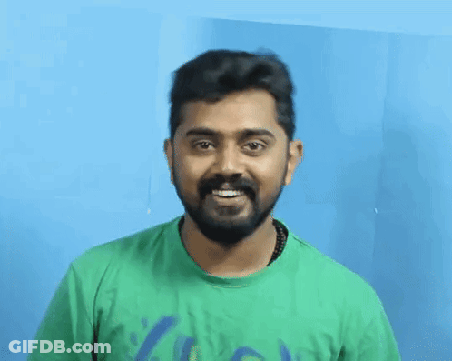 A Man With A Beard Wearing A Green T-Shirt With A Blue Graphic On It GIF