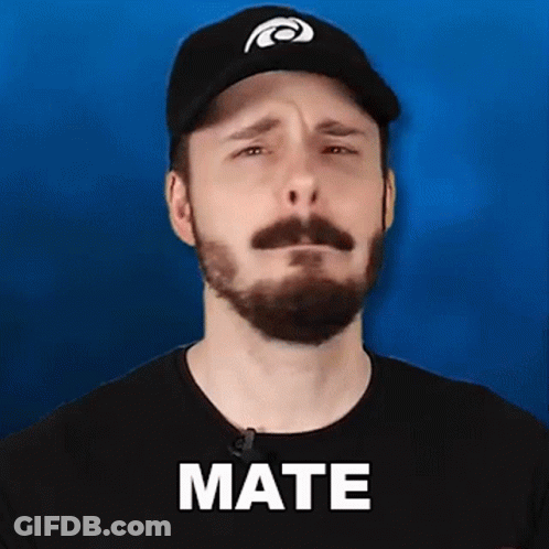 A Man With A Beard Wearing A Hat And A Black Shirt Is Making A Sad Face . GIF