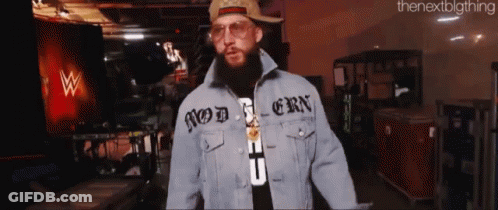 A Man With A Beard Wearing A Hat And A Denim Jacket That Says Modern On It GIF