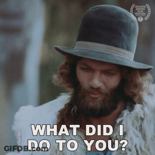 A Man With A Beard Wearing A Hat And A Fur Coat Says What Did I Do To You GIF