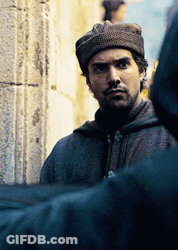 A Man With A Beard Wearing A Hat And A Hooded Jacket GIF