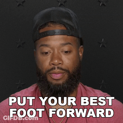 A Man With A Beard Wearing A Hat And A Red Shirt Says Put Your Best Foot Forward GIF