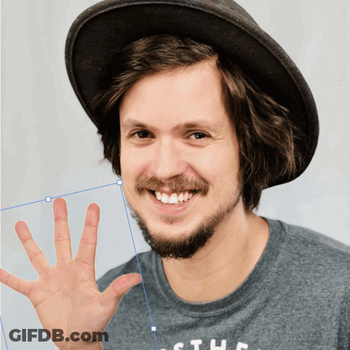 A Man With A Beard Wearing A Hat And A Shirt That Says The GIF