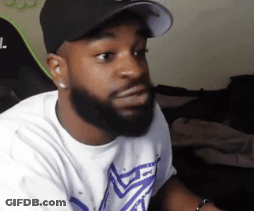 A Man With A Beard Wearing A Hat And A T-Shirt With The Letter L. On It GIF