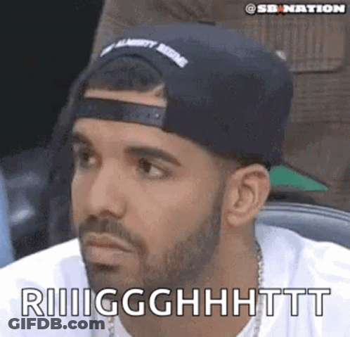 A Man With A Beard Wearing A Hat And A White Shirt Is Making A Face . GIF