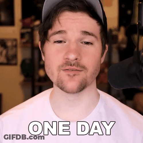 A Man With A Beard Wearing A Hat And A White Shirt That Says One Day GIF