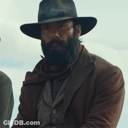 A Man With A Beard Wearing A Hat And Brown Jacket GIF
