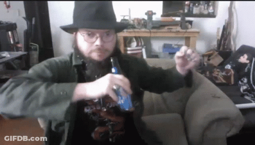 A Man With A Beard Wearing A Hat And Glasses Is Holding A Bottle Of Bud Light GIF