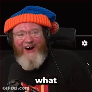 A Man With A Beard Wearing A Hat And Headphones Says The F % $ & In Front Of A Microphone GIF