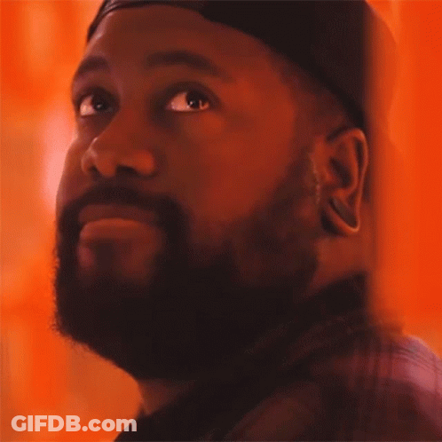 A Man With A Beard Wearing A Hat Looks Up GIF