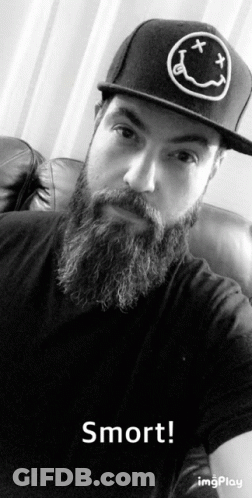 A Man With A Beard Wearing A Hat That Says Nirvana On It GIF