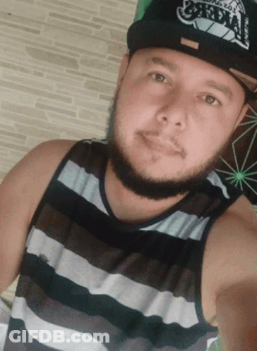 A Man With A Beard Wearing A Hat That Says ' Oakland ' On It GIF
