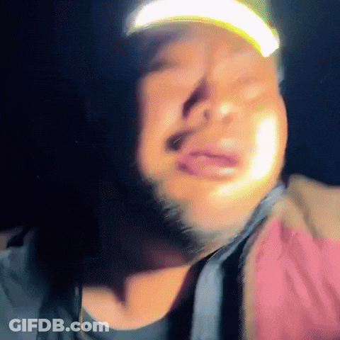 A Man With A Beard Wearing A Hat With A Yellow Light On It GIF