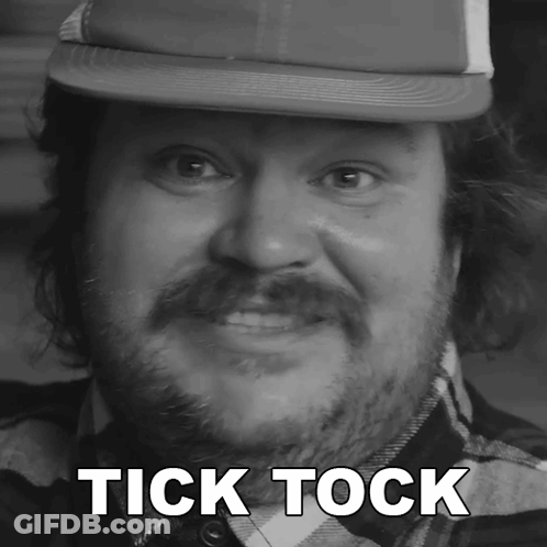 A Man With A Beard Wearing A Hat With The Words Tick Tock Above His Head GIF