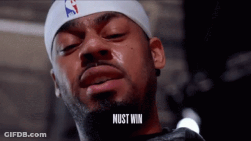 A Man With A Beard Wearing A Headband That Says Must Win GIF
