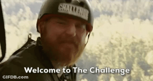 A Man With A Beard Wearing A Helmet Is Flying Through The Air And Says `` Welcome To The Challenge '' . GIF