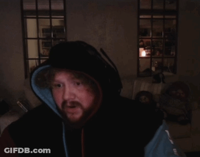 A Man With A Beard Wearing A Hoodie And Headphones Is Praying GIF