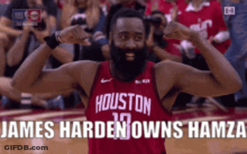 A Man With A Beard Wearing A Houston Jersey Is Flexing His Muscles . GIF