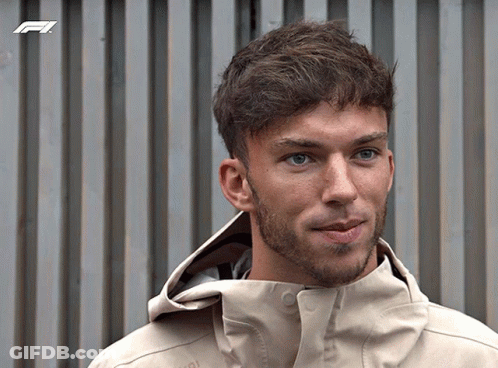 A Man With A Beard Wearing A Jacket With A F1 Logo On It GIF