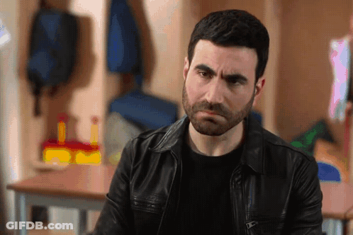 A Man With A Beard Wearing A Leather Jacket GIF