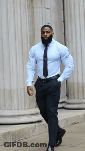 A Man With A Beard Wearing A Light Blue Shirt And Tie GIF