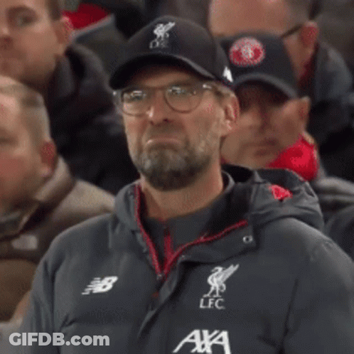 A Man With A Beard Wearing A New Balance Jacket And A Lfc Hat GIF
