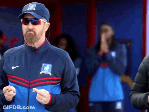 A Man With A Beard Wearing A Nike Hat And Jacket GIF