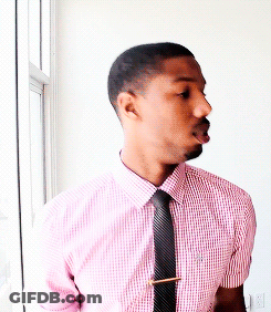 A Man With A Beard Wearing A Pink Shirt And Black Tie GIF