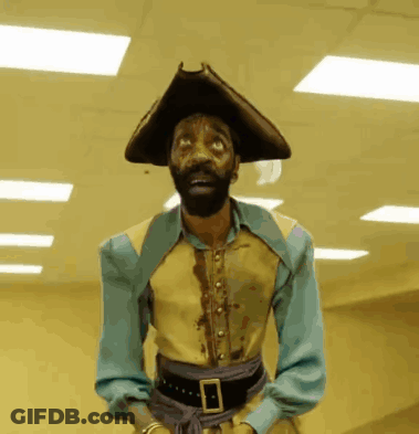 A Man With A Beard Wearing A Pirate Outfit GIF