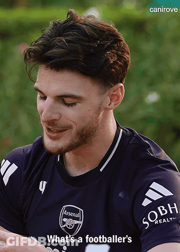 A Man With A Beard Wearing A Purple Arsenal Jersey GIF