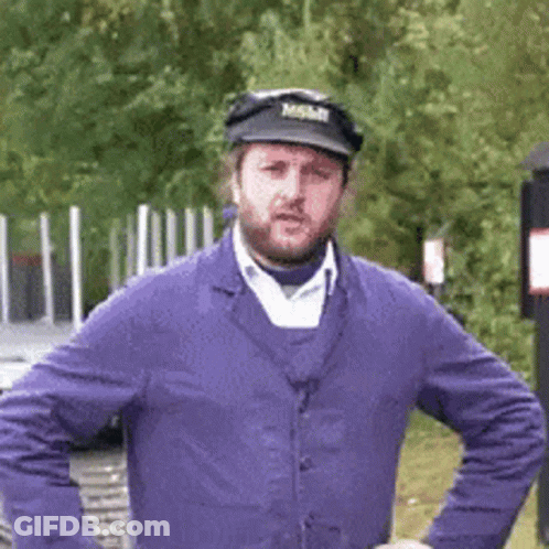 A Man With A Beard Wearing A Purple Jacket And A Black Hat With The Word Mobil On It GIF