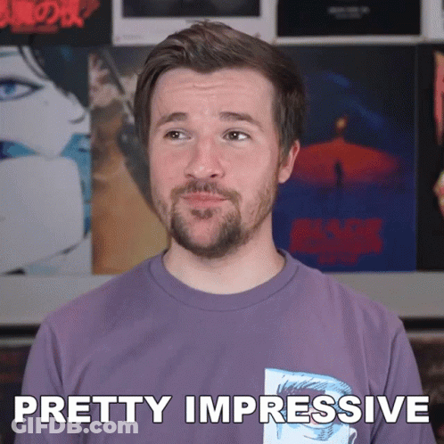 A Man With A Beard Wearing A Purple Shirt Says Pretty Impressive GIF