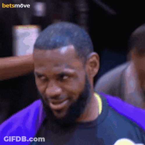 A Man With A Beard Wearing A Purple Shirt With A Betsmove Logo On The Bottom GIF
