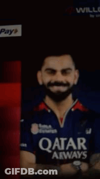 A Man With A Beard Wearing A Qatar Airways Shirt GIF