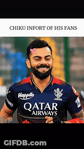A Man With A Beard Wearing A Qatar Airways Shirt Smiles GIF