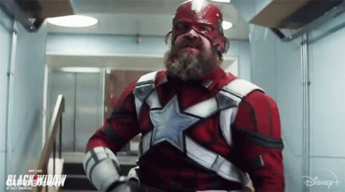 Bearded Man Standing In Hallway In Superhero Costume GIF