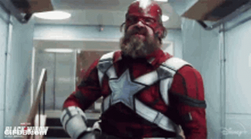 Man With Beard In Red And White Superhero Costume GIF