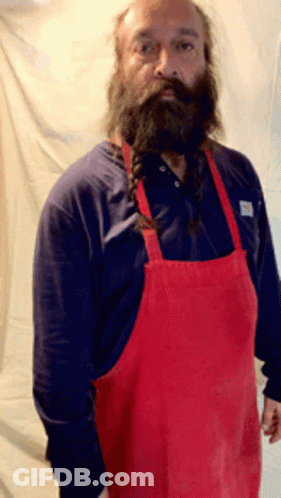 A Man With A Beard Wearing A Red Apron And A Blue Shirt GIF
