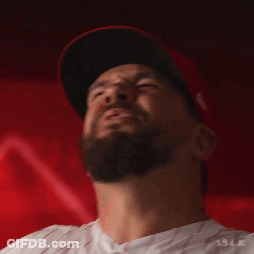 A Man With A Beard Wearing A Red Hat GIF