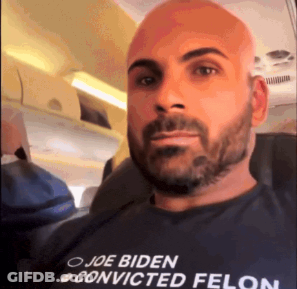 A Man With A Beard Wearing A Shirt That Says Joe Biden Convicted Felon GIF
