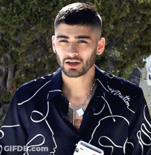 A Man With A Beard Wearing A Shirt That Says Louis Vuitton On It GIF