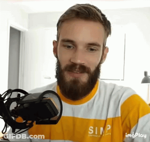 A Man With A Beard Wearing A Shirt That Says Simp On It GIF