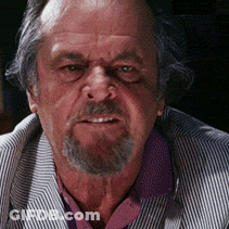 A Man With A Beard Wearing A Striped Jacket And A Purple Shirt GIF