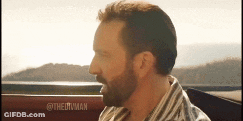 A Man With A Beard Wearing A Striped Shirt Is Sitting In A Car GIF