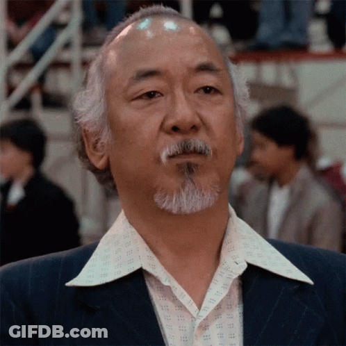 A Man With A Beard Wearing A Suit And A White Shirt GIF