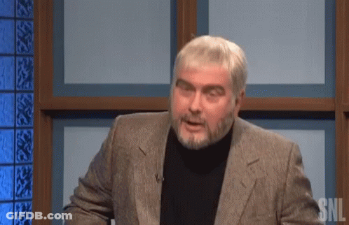 A Man With A Beard Wearing A Suit And Black Turtleneck Is On Snl GIF