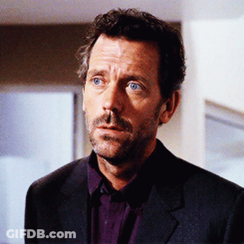 A Man With A Beard Wearing A Suit And Purple Shirt GIF