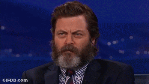 A Man With A Beard Wearing A Suit And Tie Is Smiling GIF