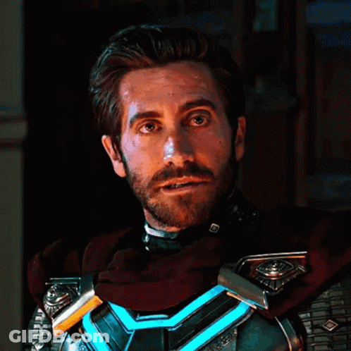 A Man With A Beard Wearing A Superhero Costume Is Looking At The Camera . GIF