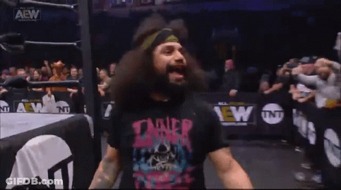 A Man With A Beard Wearing A T-Shirt That Says Tainer GIF
